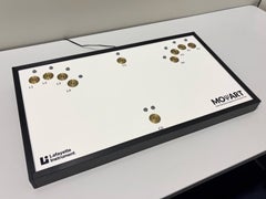 MOART psychomotor testing console featuring a white tabletop panel with gold button pads and indicator lights