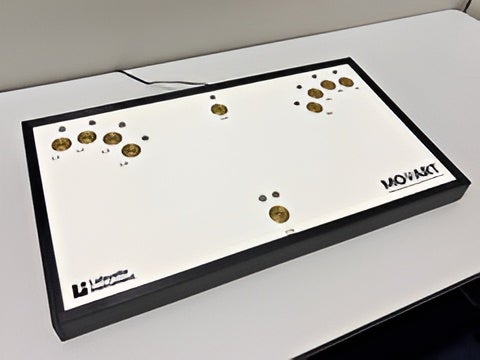 MOART psychomotor testing console featuring a white tabletop panel with gold button pads and indicator lights