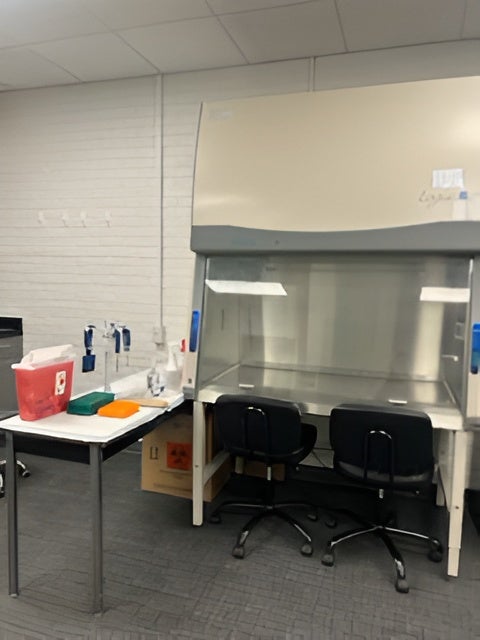LABCONCO Purifier biological safety cabinet with two ergonomic lab chairs and a prep cart